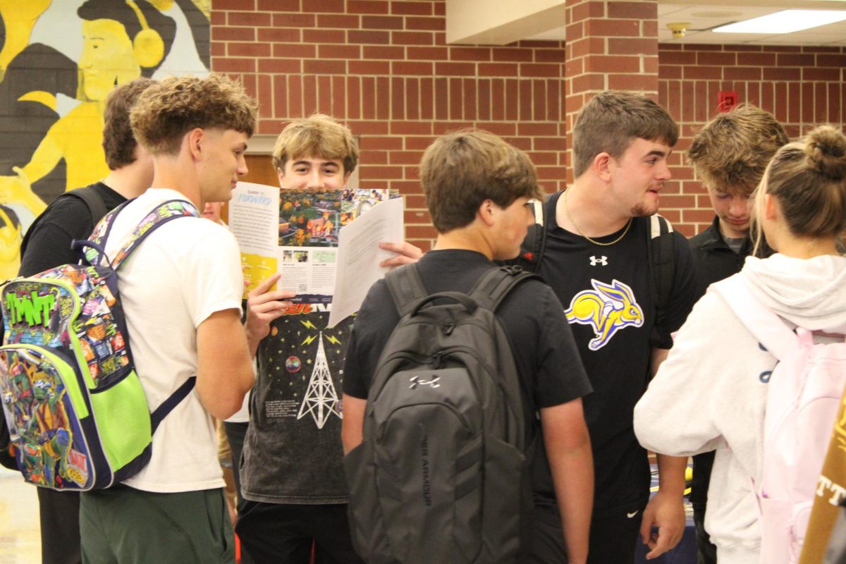 Corbin Ritter, Sawyer Tarrel, Gavin McLaren, and Sam Brosam congregate to talk about the college tables they have stopped by.