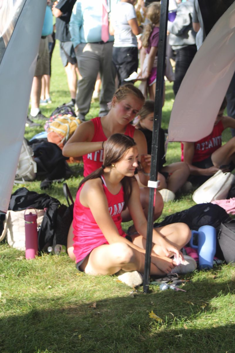 Senior Bella Brock braids freshman Kaitlyn Hickman's hair. Braiding hair is a great way to grow relationships between teammates and a fun way to bond with the team and form relationships. 