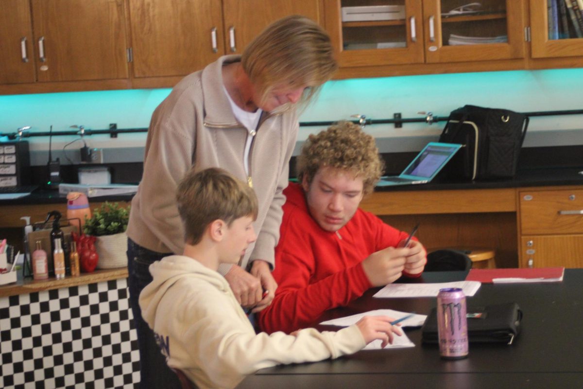 Mrs.Franken is helping Bobby Robert and Naoh Lagassie with their work.