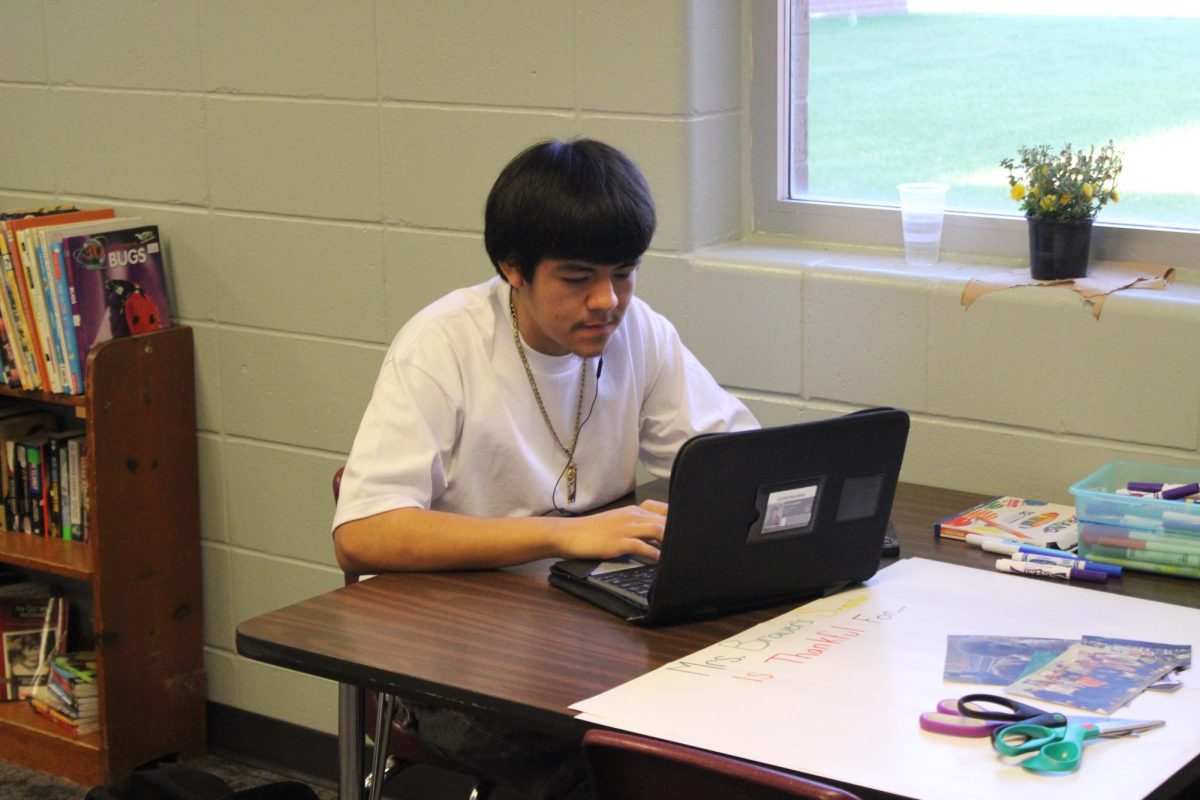 Alan Damian is on his computer working for finance.