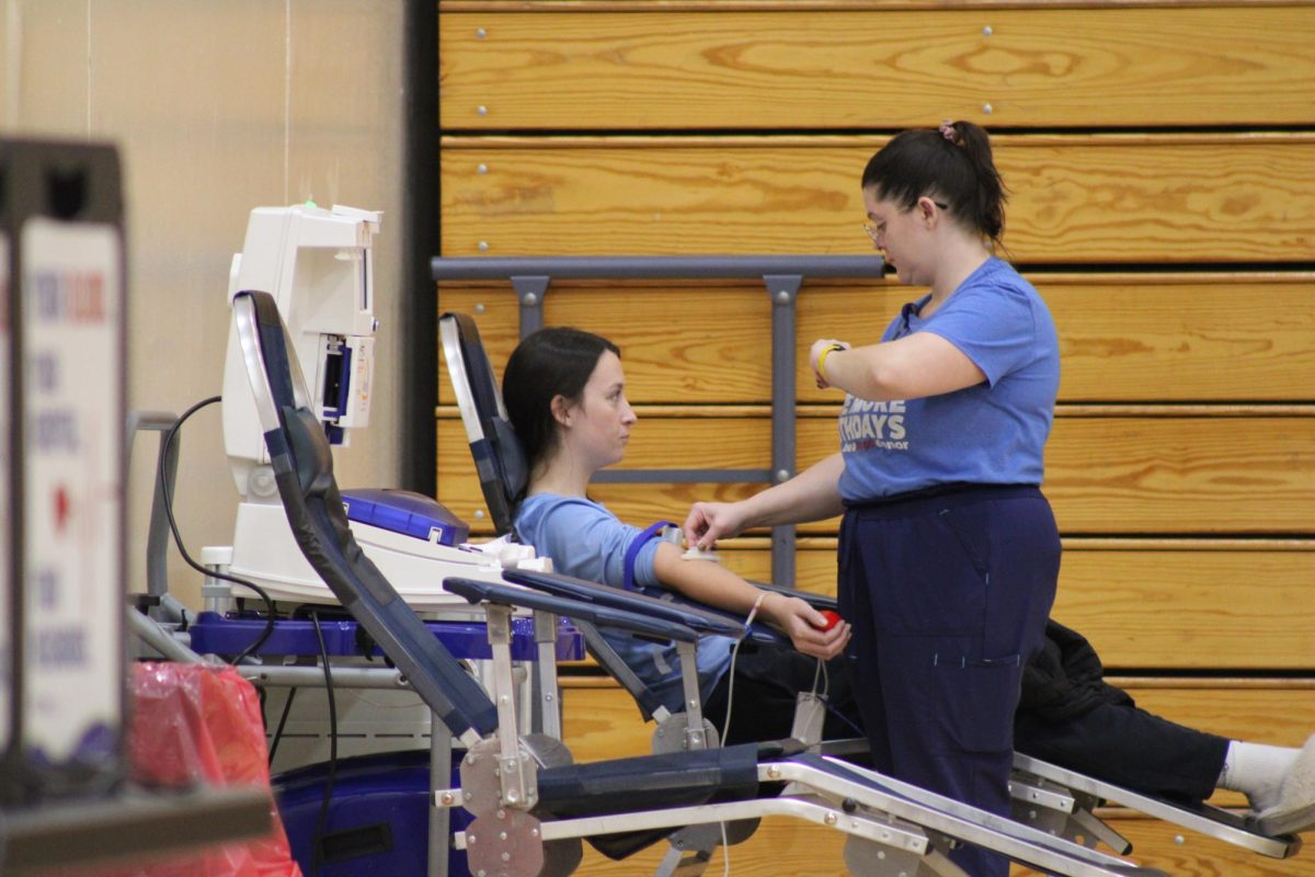Senior Lily Johnson focus on a distraction so she wouldn't feel the needle went into her skin. The National Honor Society blood drive on was held on Nov. 19.