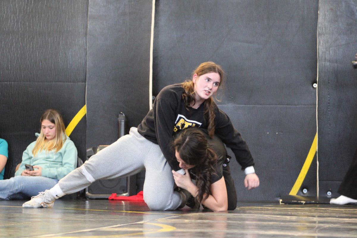 Junior Alivia Knuth and Senior Lily Johnson were practicing take downs for practice.