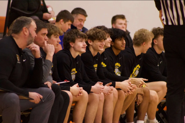 All smiles on the bench. Last year's boys' basketball players cheered on their teammates. The boys are excited for this year's season to start, and see what it brings. 