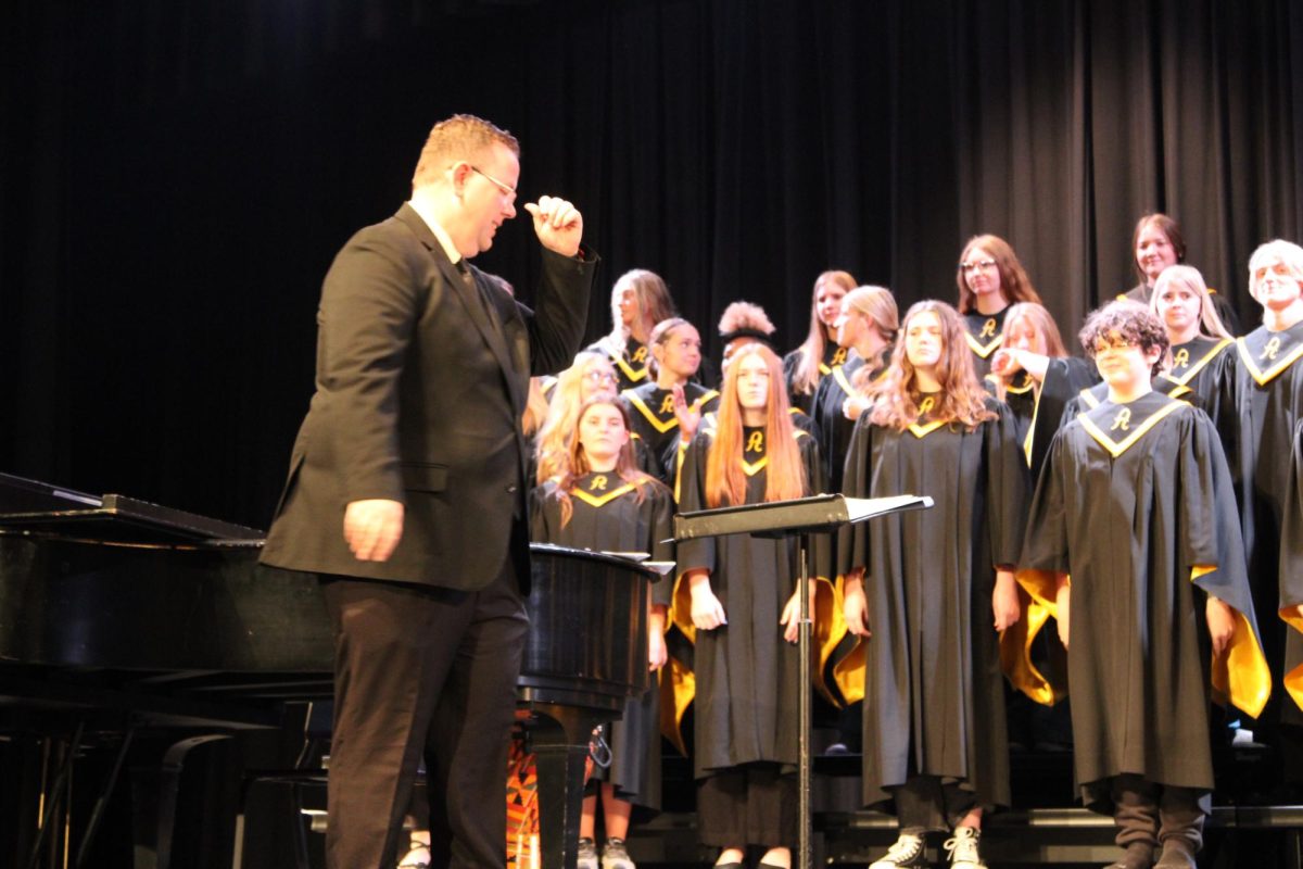Jarrod O'Donnell takes the stage to conduct the choir members. This is the fall concert and O'Donnell's first directing of the choir. The concert is beautiful and the students sang great.