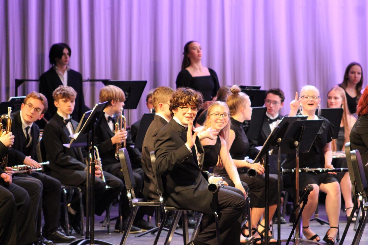 Sophomores, Holly Petersen and David Blake are waving hello to acknowledge the audience's support. They prepared to entertain guests with music after this shared experience.