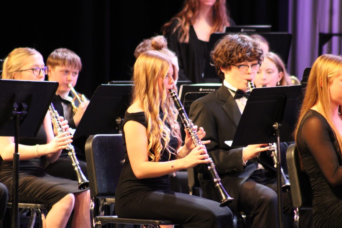 Jayna MacEntaffer and David Blake follow the music under the lights. Their tone and rhythm blended together in the clarinet section. 