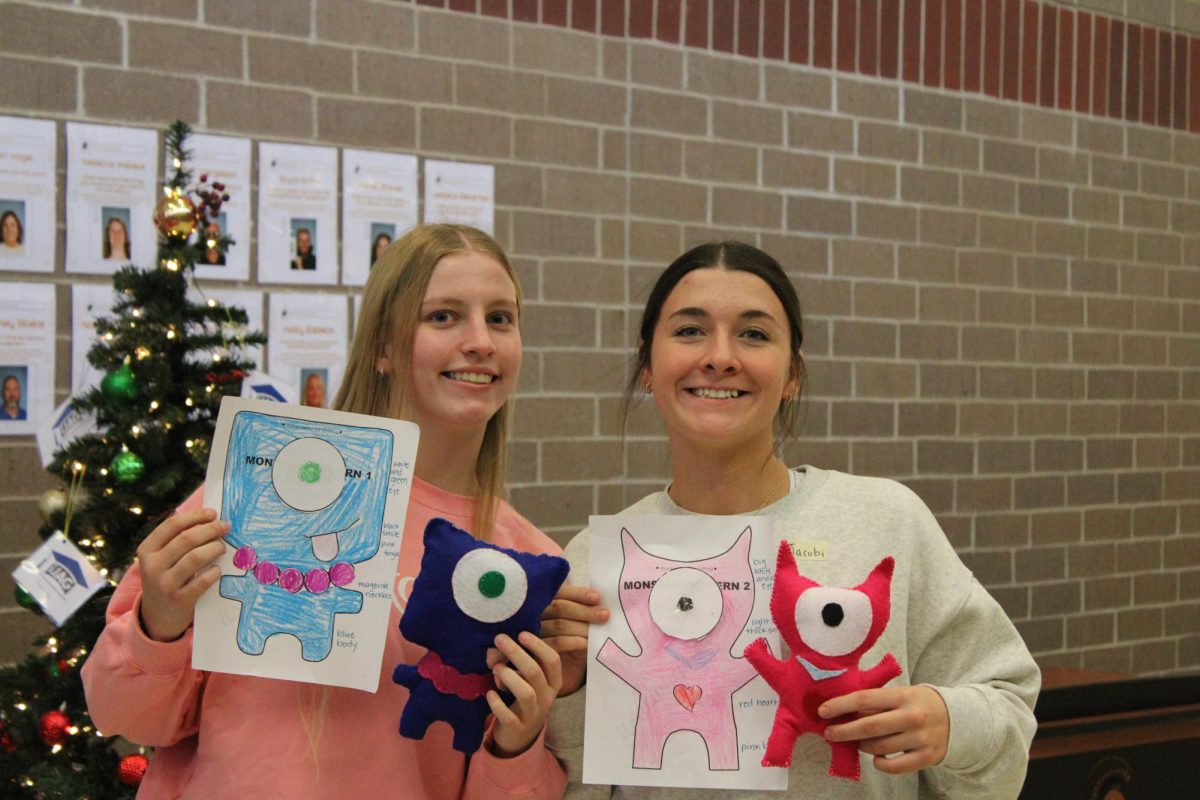 Freshman Maddie McLaren and Junior Jacobi Harter are getting ready to go visit Washington elementary.Their going to visit the little kids to give them their stuffed monsters and read to them.