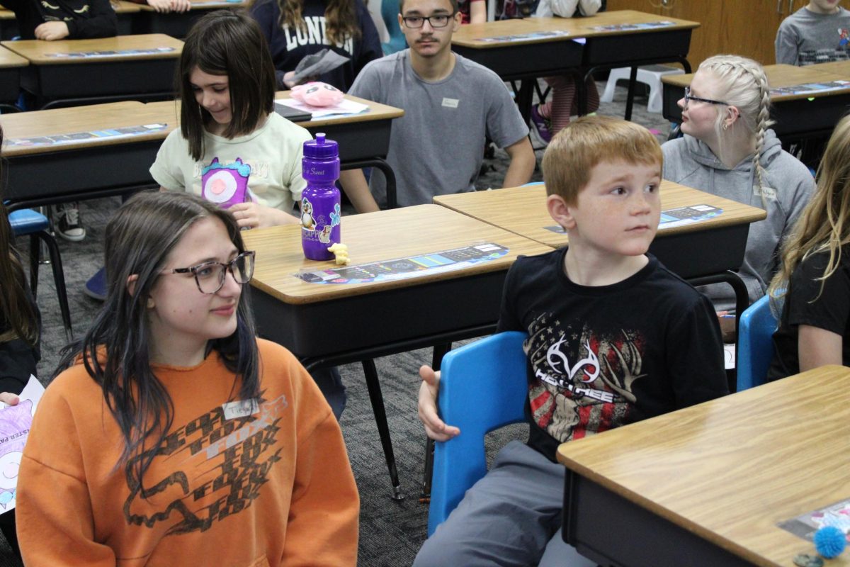 Sophomore Tiegan Daniel and her partner from Washington elementary.They we're both looking at the teacher while the teacher was talking about the instructions.