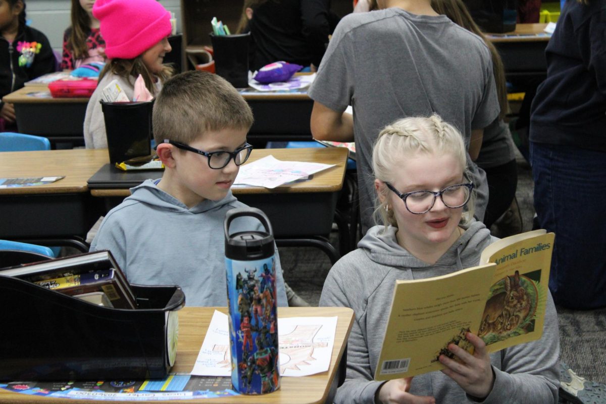 Sophomore Ashlynn Albert reads a book to her 2nd grade partner.Students in teacher Nicole Korpela's class participated this year.FCS teacher Rebecca Wallace came up with the idea several years ago.