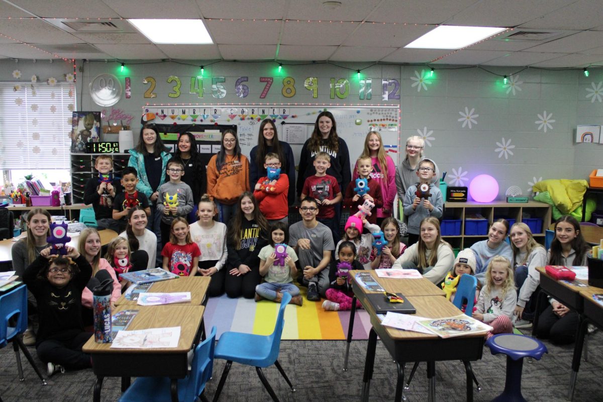 Intro to FCS students present their felt monsters to second-graders at Washington Elementary. The children designed their monsters. Then the high-school students sewed the stuffed creatures.