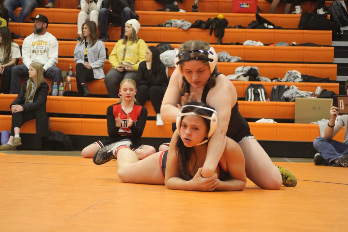 Leiah Thomas stays in control on top. She worked to press her opponent's head toward the mat. Her technique helped her maintain control.