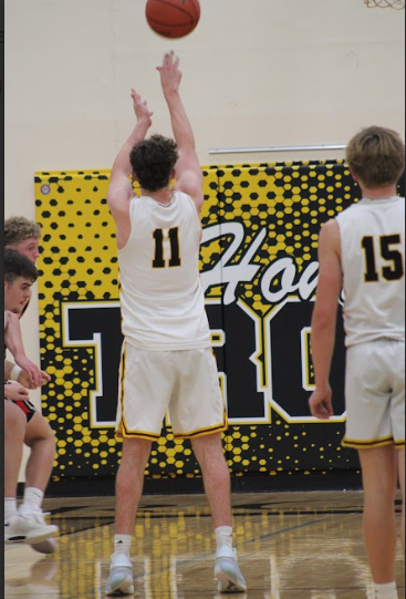 Senior Kale Jensen shoots a free throw. Jensen shot with correct form as he went for the single point for his team. The other players box out in attempt to rebound a missed shot. 