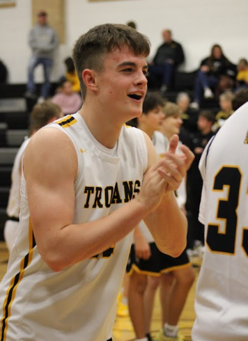 Freshman Benny McLaren cheers for his team as they warm up. McLaren got in line of a warm-up drill and cheered while he waited. 