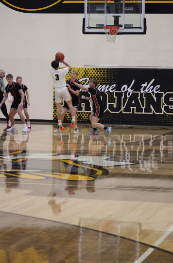 Hunter Nelson going for the fade-away. Nelson is guarded by two defenders and still took the shot. He wanted to contribute to the team. 