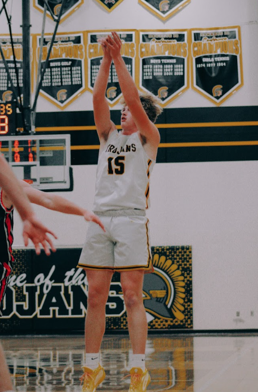 Sophomore Grant Petty pulls up and takes a three point shot. He focused on the shot as he held his follow through in hope for the make. 