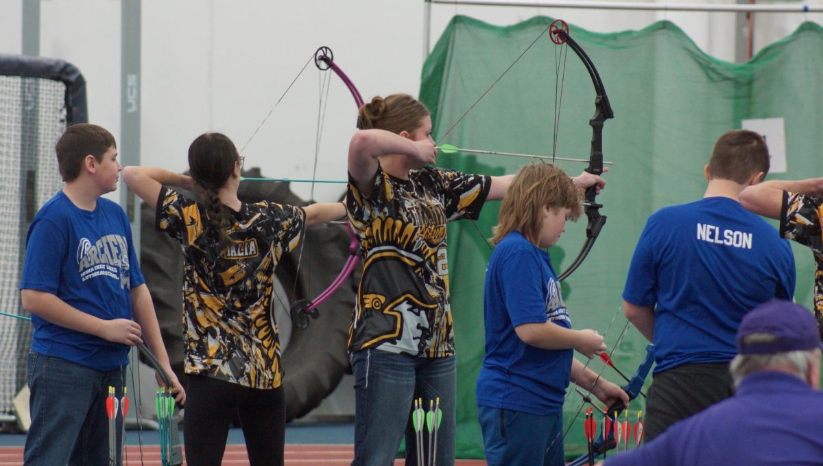 Trojan archers draw their bow, taking aim at the target.