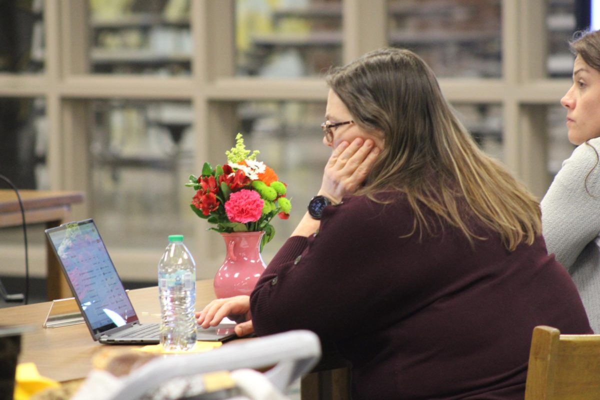 Laura McLean listens in on the School Board proceedings at her last meeting as a board member.