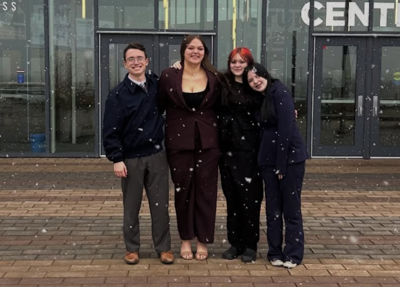 The AHS Debate team stands outside the DMACC campus where the tournament was held.