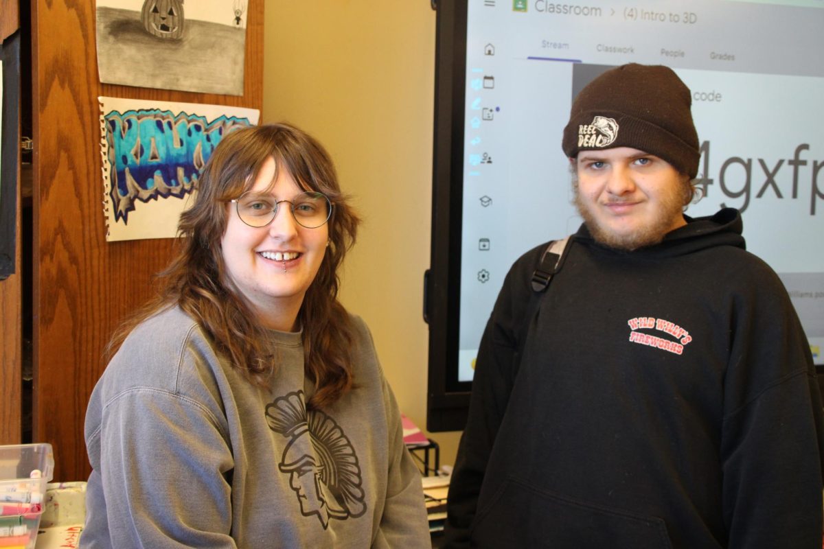 Art teacher Liz Herrick works alongside 