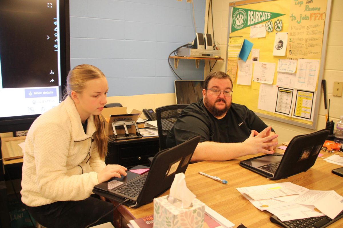 FFA advisor Eric Miller alongside Claire Schroeder prepare upcoming meeting. Winter formal details were being finalized before the voting process.