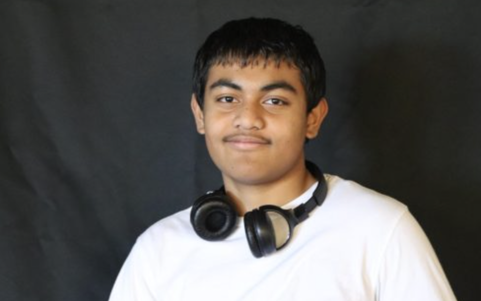 AHS Journalist Boboy Wallipy wears headphones around his neck. 