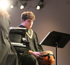 Senior Fletchor Toft plays the Djembe during “Rain Music.”