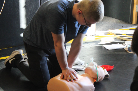 Eric Albert practices CPR on  one of the CPR dummies. 