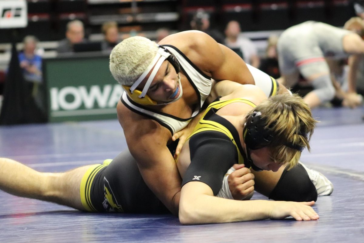 Senior Donovan Hedrington goes for the back points as he tries to turn his opponent. Hedrington won this match to qualify for the second day of the state tournament. He wrestled at the 190 pound weight class for his senior season. 