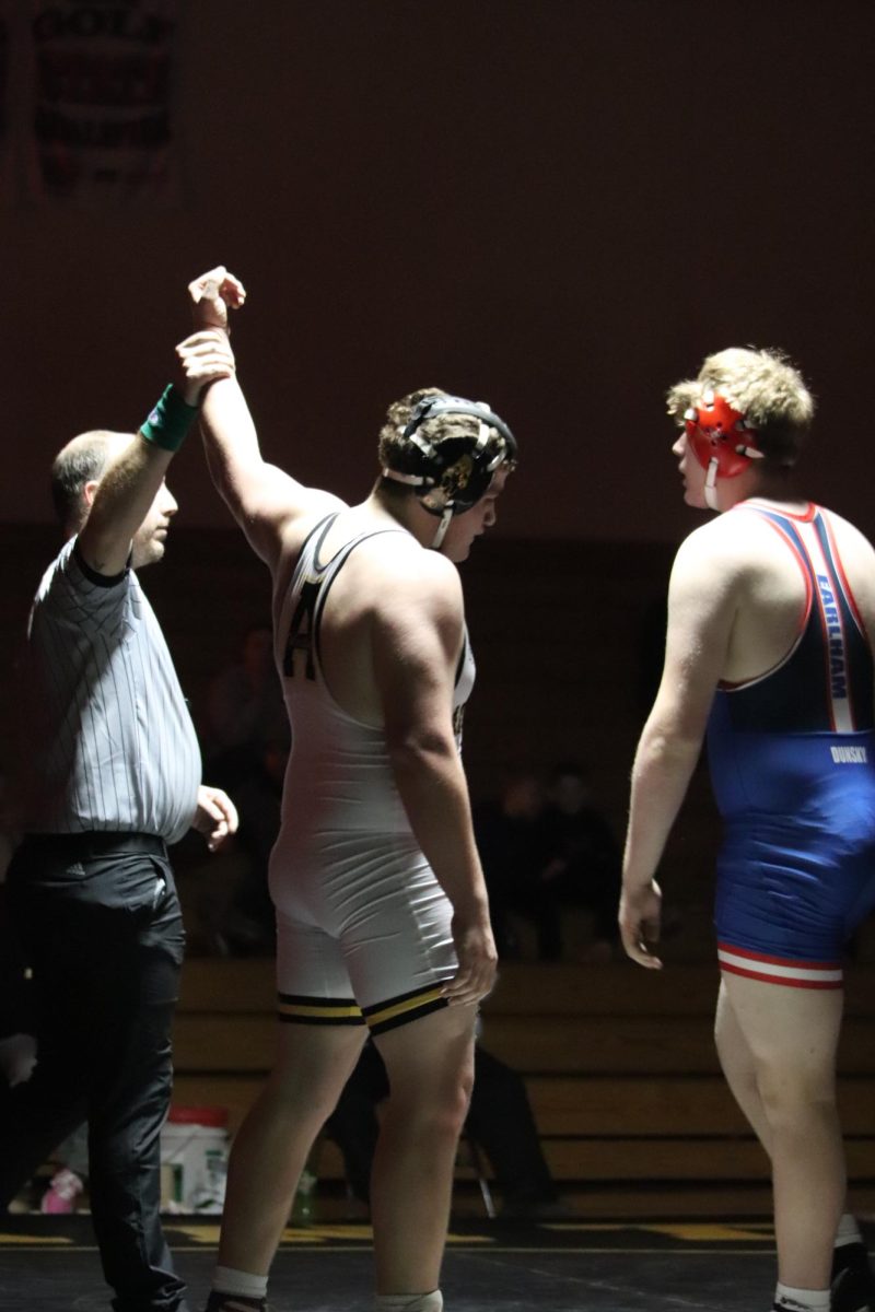 Travin Thomas takes a victory during the match against Earlham.