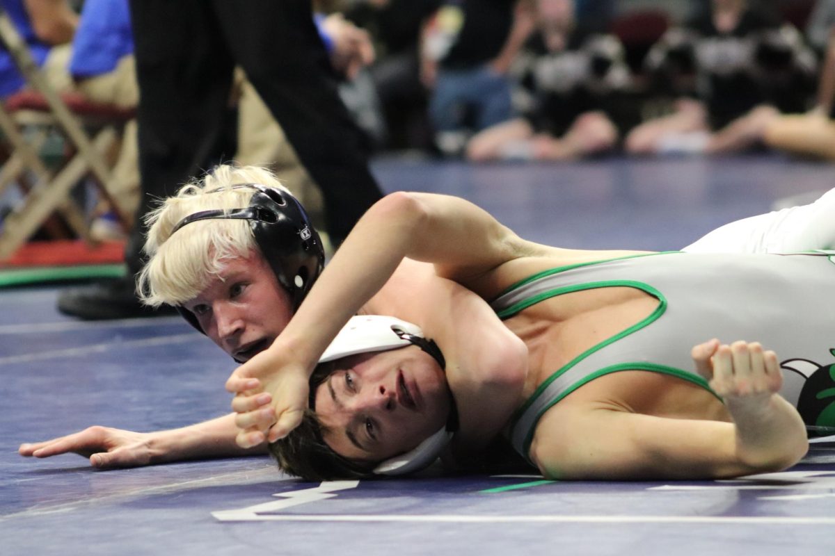 At 106 pounds Dayton Vanhorn looks to the referee to count back points for the position he has forced his opponent to. He turned his opponents once more earning the win. Last year Van Horn was a junior varsity wrestler. This year he took a run at state and made his way to the podium placing eighth. 