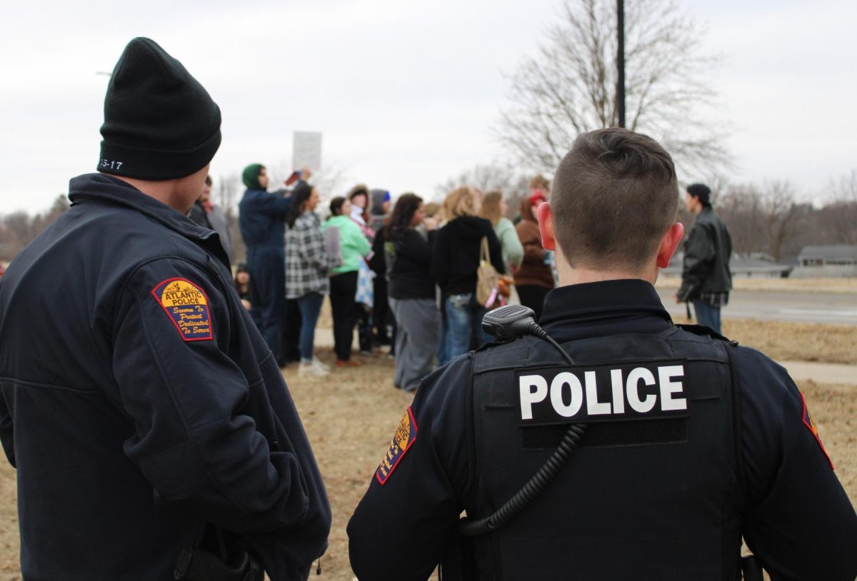 Two police officers look on during the Feb. 6 "Fire McCann" walk out.