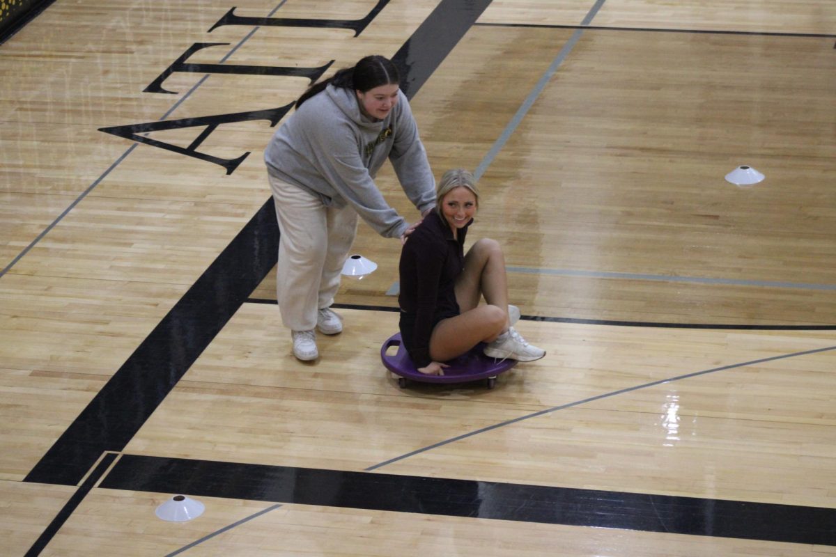 Freshman Natalie Crackovich and senior Madelyn Anderson smile at the silliness of the game. Natalie said it was scary to get hit by Dodge balls in the face.