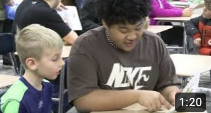 Salimor Rax reads to one of the kids from Washington.