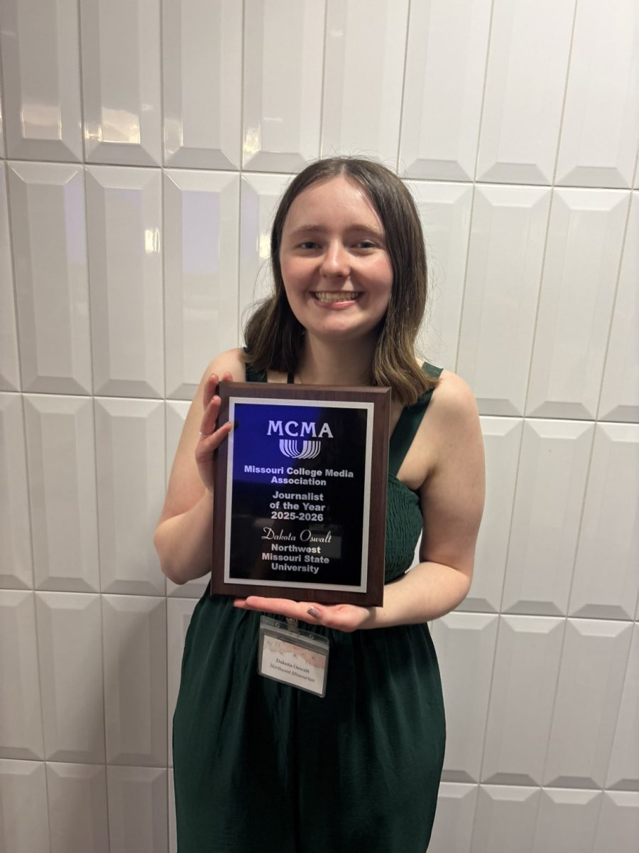 Oswalt holds her Journalist of the Year award. Photo by Hannah Claywell, EIC of The Missourian 2026