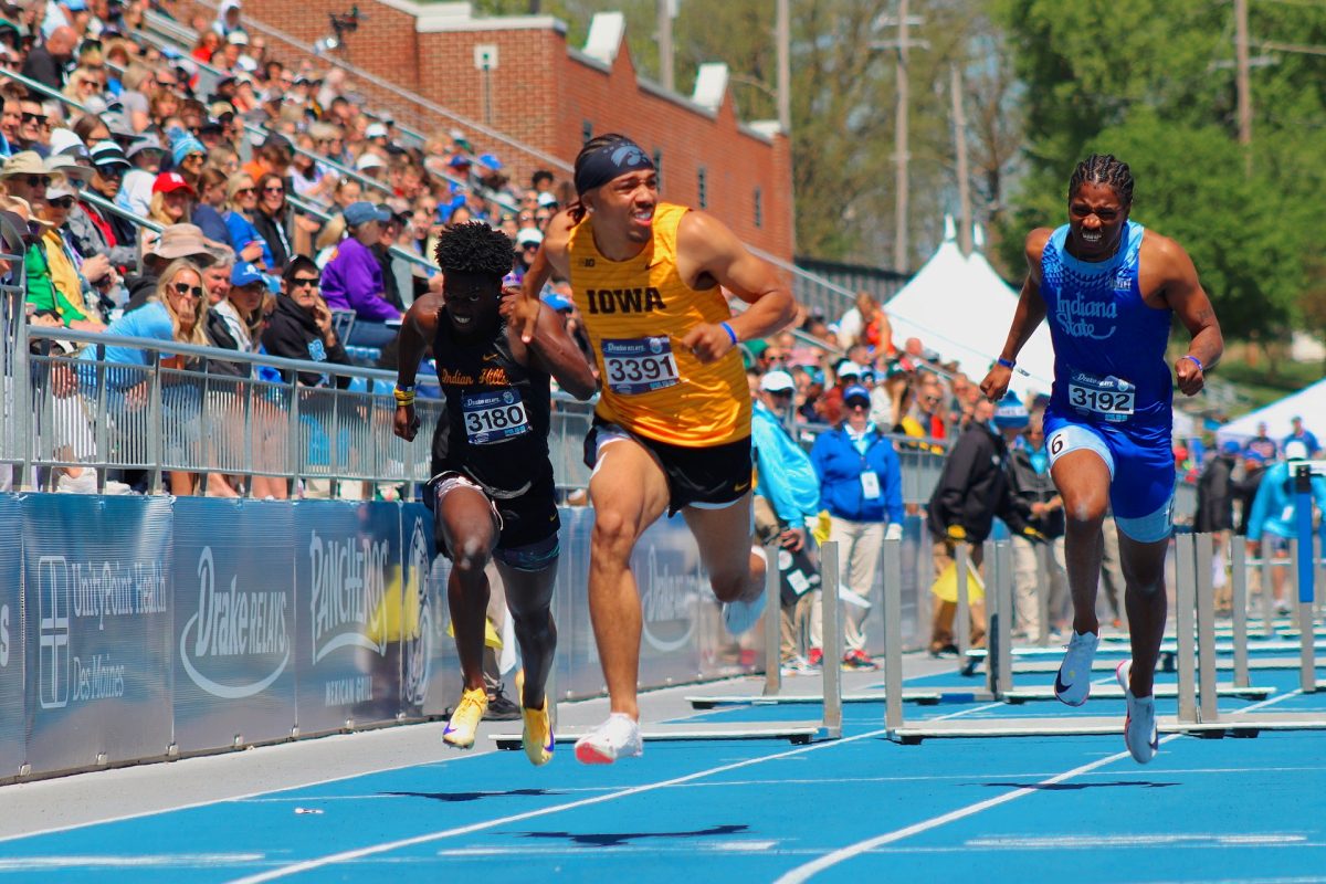 High emotion as an University of Iowa athlete crosses the finish line with a close win, during the 110m hurdles. 