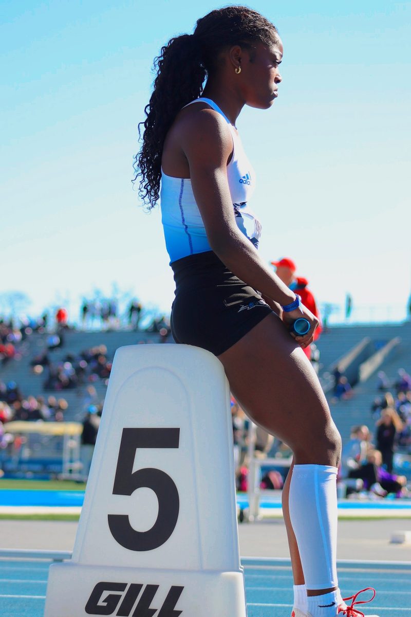 Athlete mentally preparing to compete in a race, locking in for a crucial win to move on to the finals at the Drake Relays