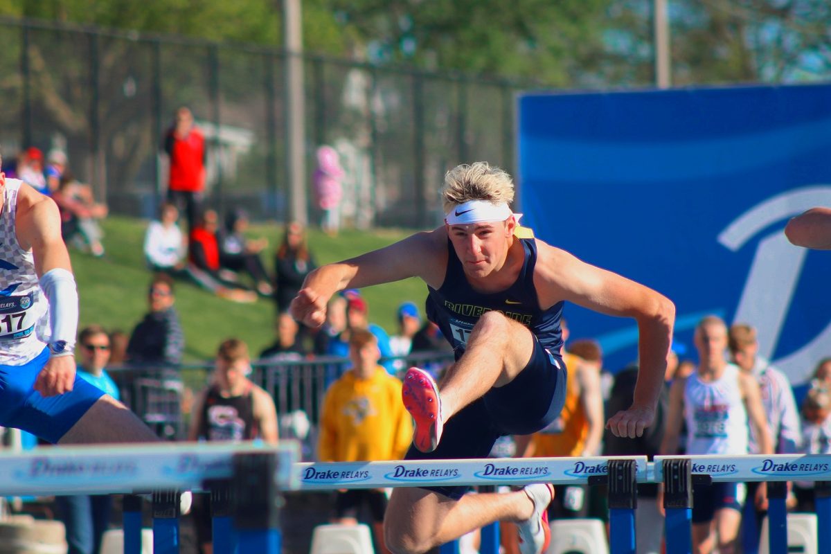 Riverside athlete going over the first hurdle during the competitive race. 
