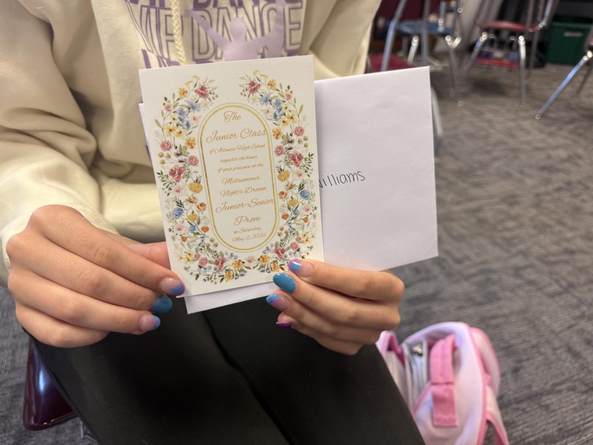 A senior holds her invitation to prom. 