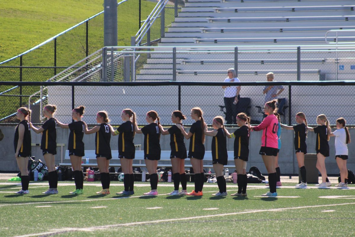 Atlantic Girls Soccer team pledge their alligence to the United States before the start of the game.