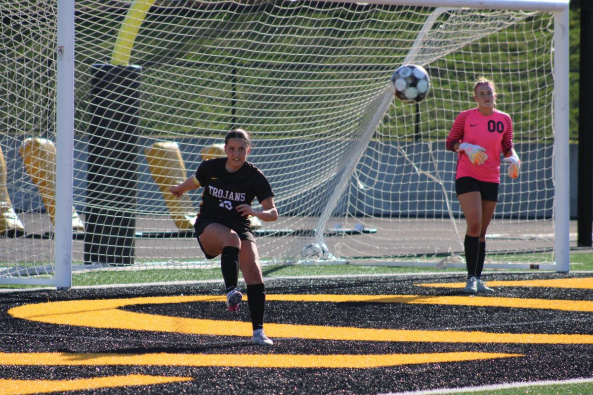 Atlantic defender Lucy Cohrs clears the ball away from Atlantic goal keeper Clara Kennedy.