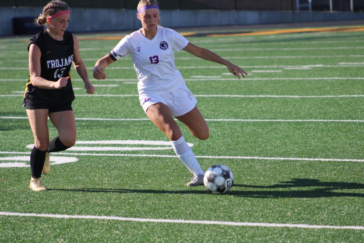 West Central Valley midfielder Addilynn Richter and Atlantic midfielder Chloe Lillard compete for control over the ball. 