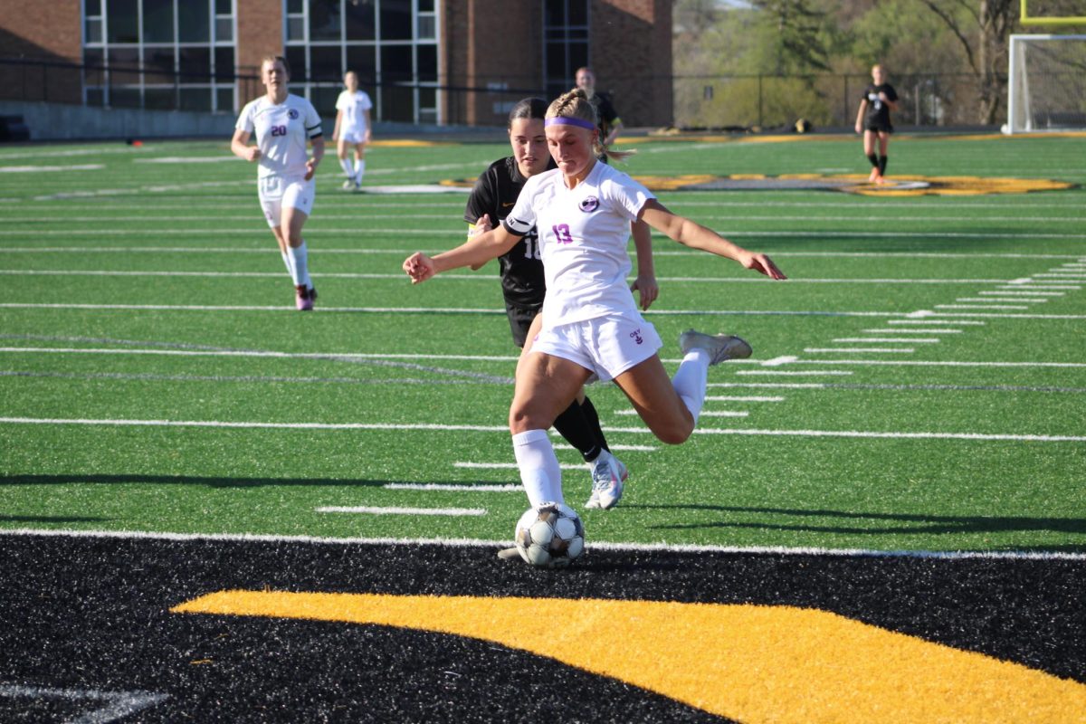 West Central Valley midfielder Addilynn Richter goes in for a goal while being defended by Atlantic defender Lucy Cohrs.