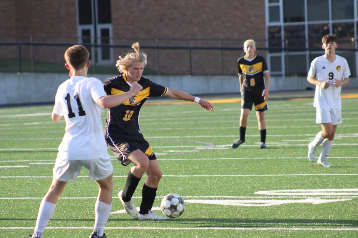 Atlantic forward Caleb Anderson possesses the ball while under pressure by Tri-Center.
