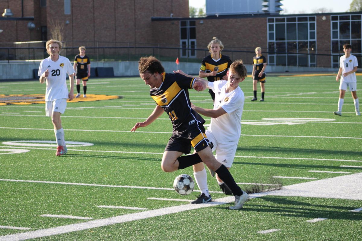 Atlantic midfielder Ismael Elba is shoved by the opposing team while competing for control over the ball.