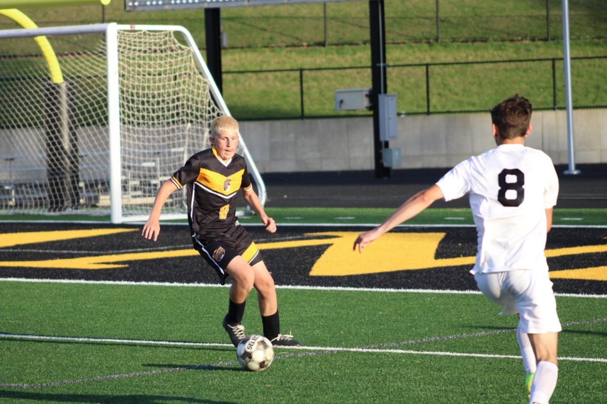 Atlantic defense Brandon Wagner competes over the ball with Tri-Center defense Carter Gittens.