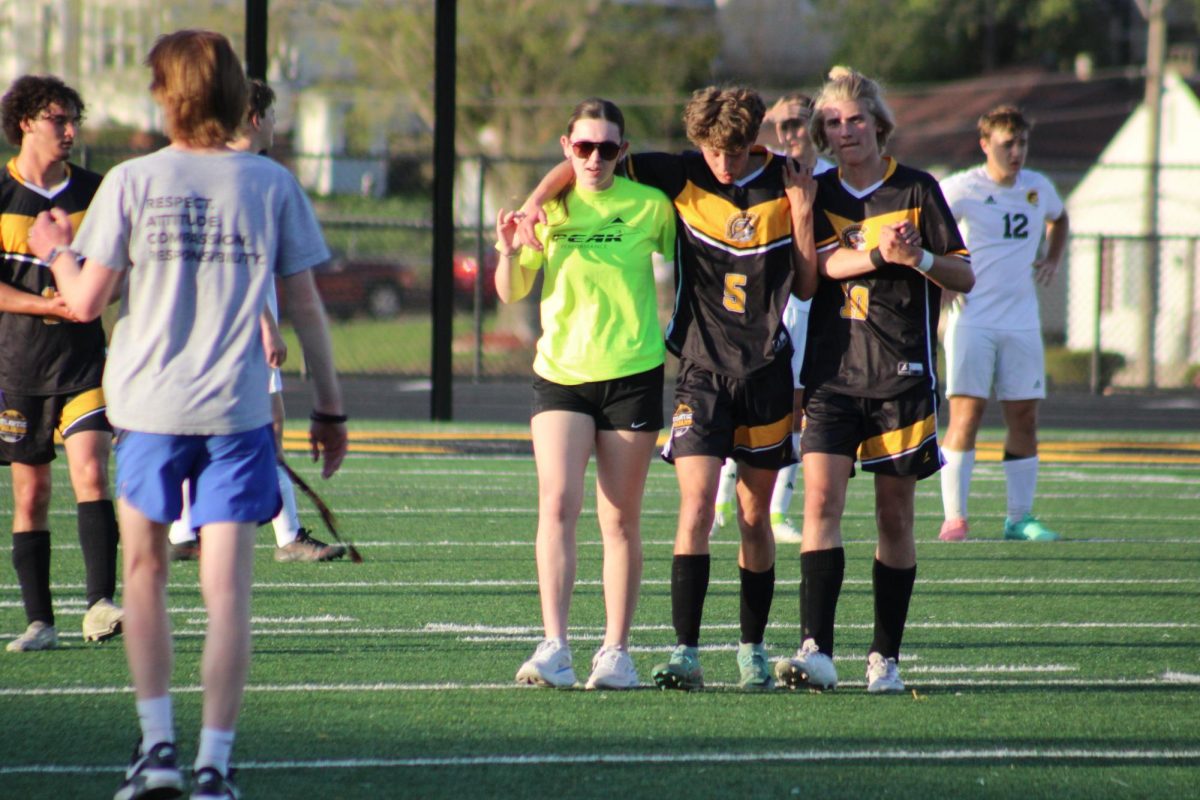 Atlantic forward Justin Smith is helped off the field after a collision with an opposing player from Tri-Center.