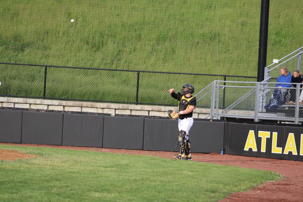 Senior Gavin McLaren passes the ball to the pitcher.