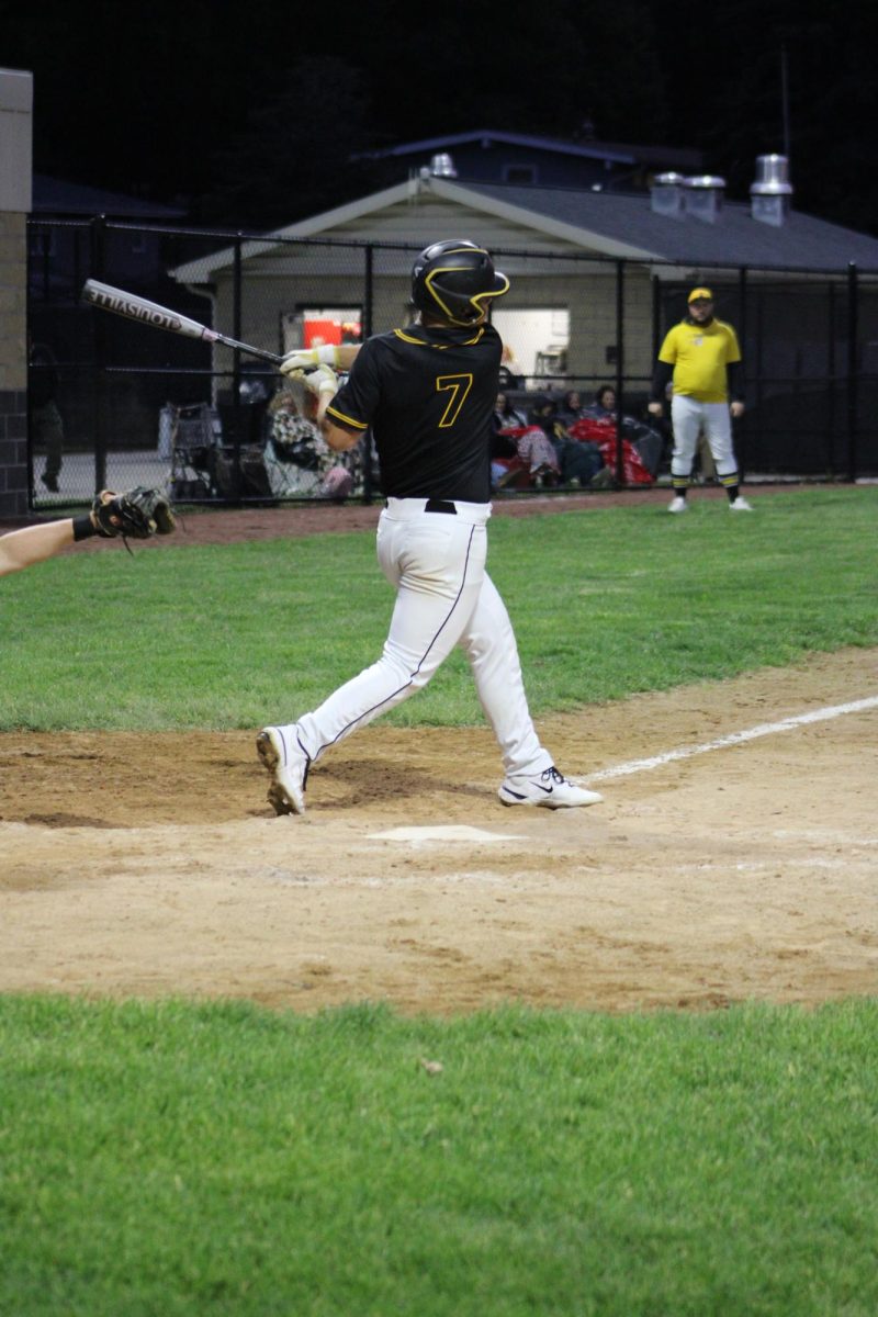 Senior Zayden Parker swings the bat.